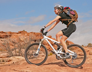 healthy woman on Utah bike trail with backpack