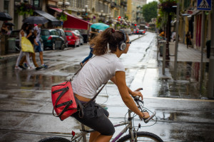 woman wearing headphones on a bike