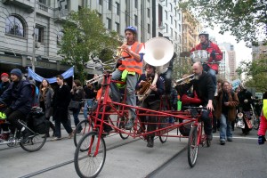 Men playing instruments on a bike