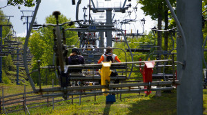 Cyclists and their bikes ride a ski lift