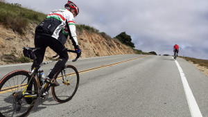 Man cycles on a long stretch of road